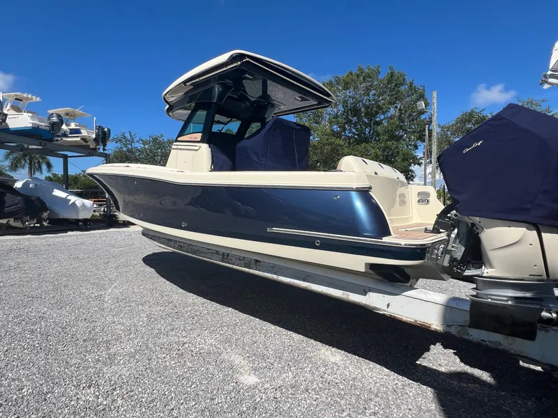Slide: The Image of 2024 Chris-Craft Catalina 30 boat on trailer under clear blue sky. - 3
