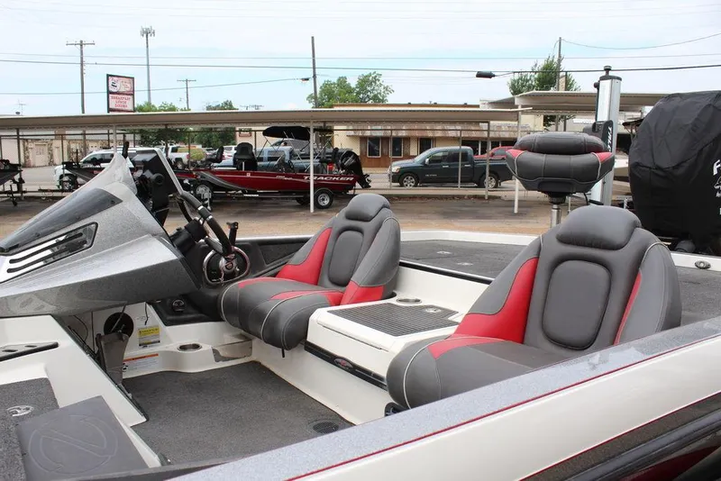 Slide: The Image of 2018 Ranger Z520C boat interior with red and gray seats at a dealership. - 12