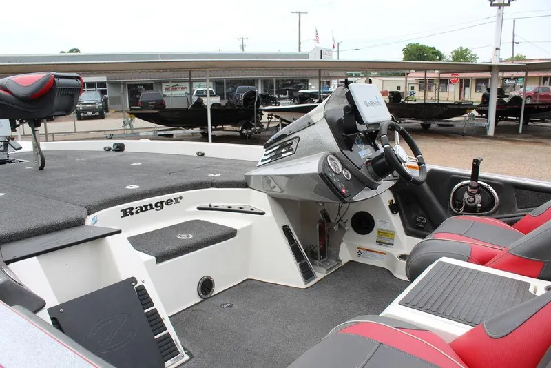 Slide: The Image of 2018 Ranger Z520C boat interior with steering console and seating. - 13
