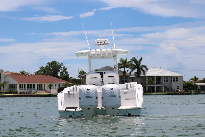 Slide: The Image of 2016 Stamas 317 Tarpon boat with twin Suzuki engines on the water. - 2