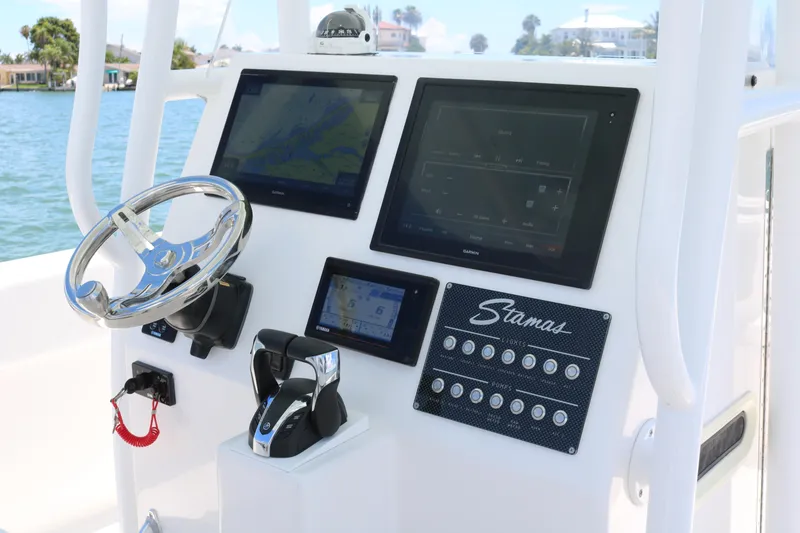 Slide: The Image of 2016 Stamas 317 Tarpon boat dashboard with navigation screens and controls. - 22