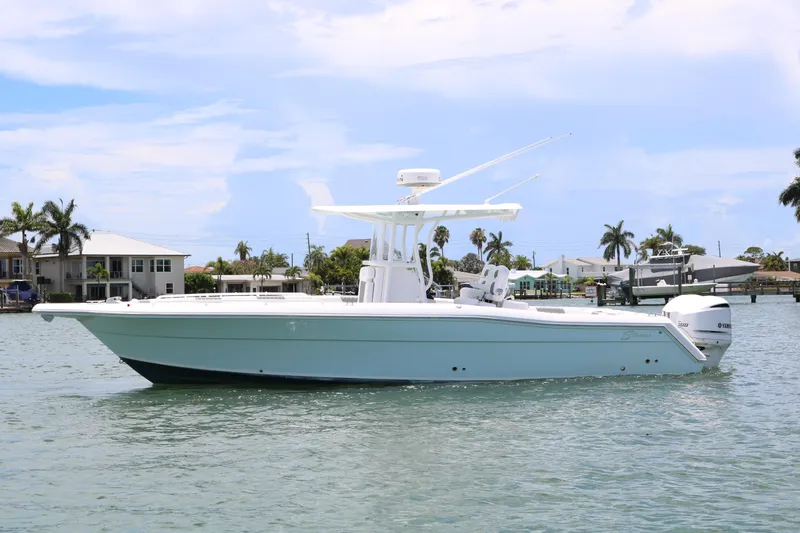 Slide: The Image of 2016 Stamas 317 Tarpon boat on calm waters with a coastal background. - 4
