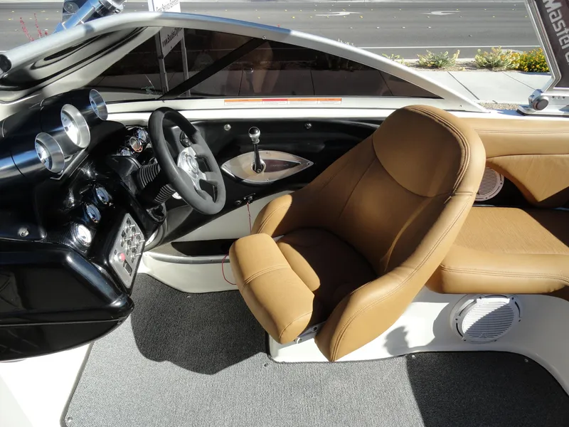 Slide: The Image of 2007 MasterCraft X-Star boat interior with tan leather seats and modern dashboard. - 12