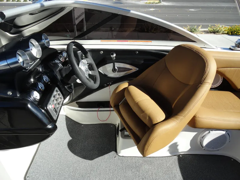 Slide: The Image of 2007 MasterCraft X-Star boat interior with tan leather seats and modern dashboard. - 13