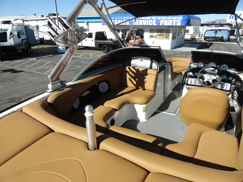 Slide: The Image of 2007 MasterCraft X-Star boat interior with tan leather seats and modern dashboard. - 15