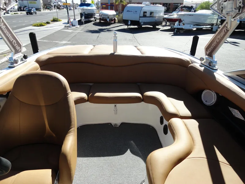 Slide: The Image of 2007 MasterCraft X-Star boat interior with tan leather seating and carpeted floor. - 18