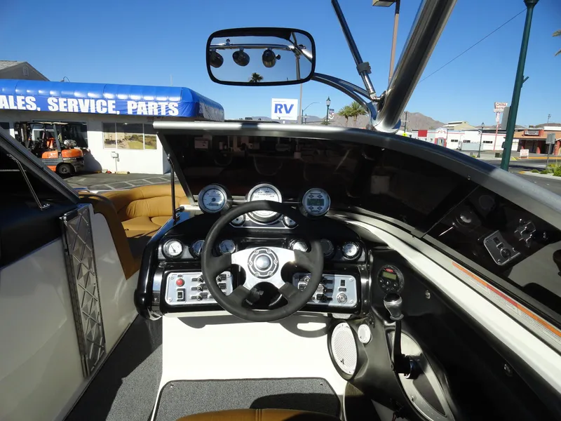 Slide: The Image of 2007 MasterCraft X-Star boat dashboard with steering wheel and control panel. - 8