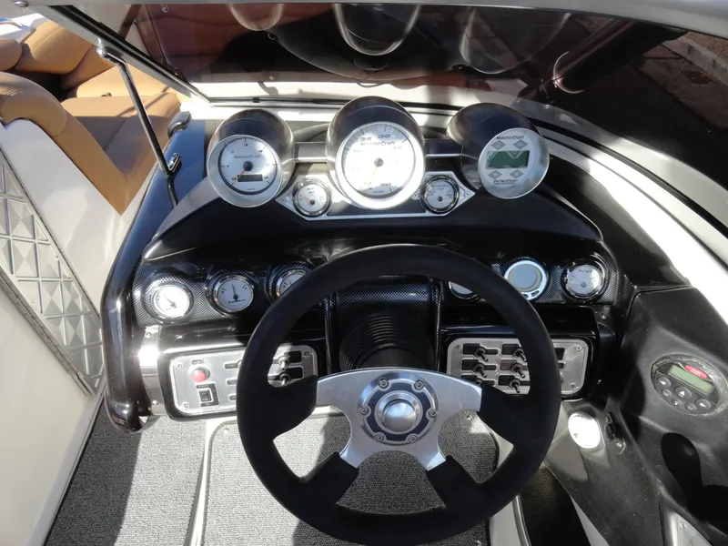 Slide: The Image of 2007 MasterCraft X-Star dashboard with steering wheel and gauges. - 9
