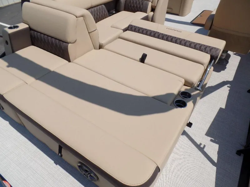 Slide: The Image of 2025 Harris Sunliner 250 boat with beige seating and cup holders. - 10