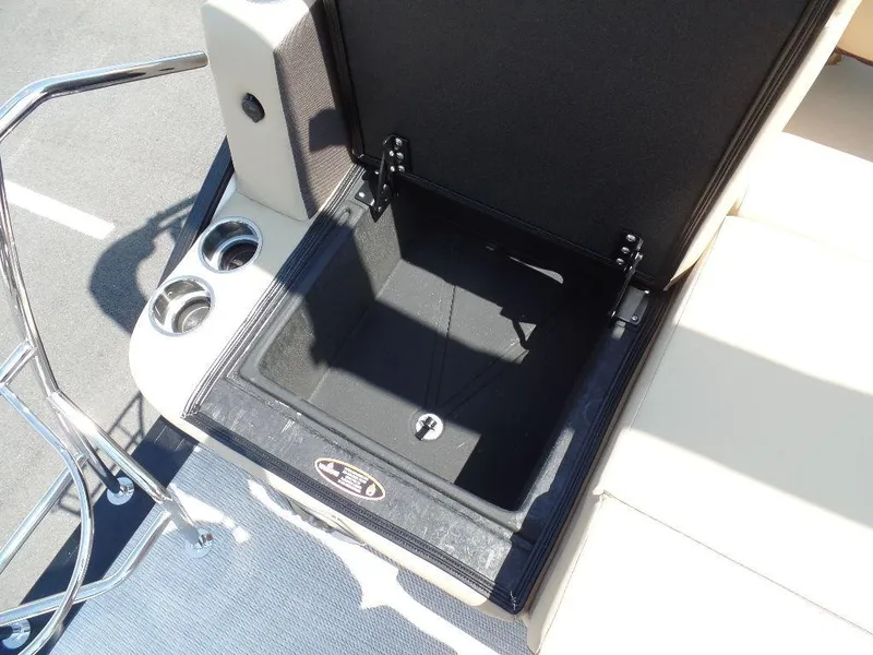 Slide: The Image of Open storage compartment on 2025 Harris Sunliner 250 boat with cup holders. - 11