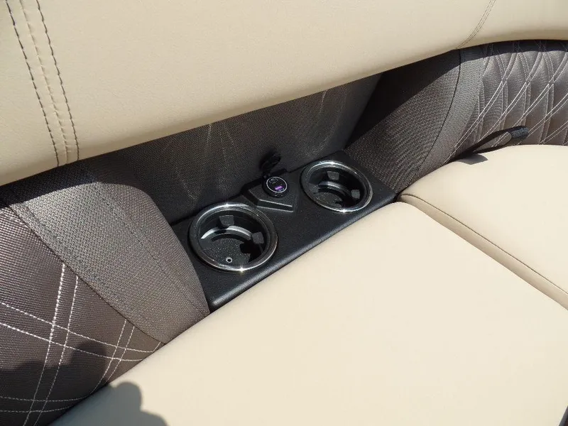 Slide: The Image of 2025 Harris Sunliner 250 interior with beige seating and dual cup holders. - 13