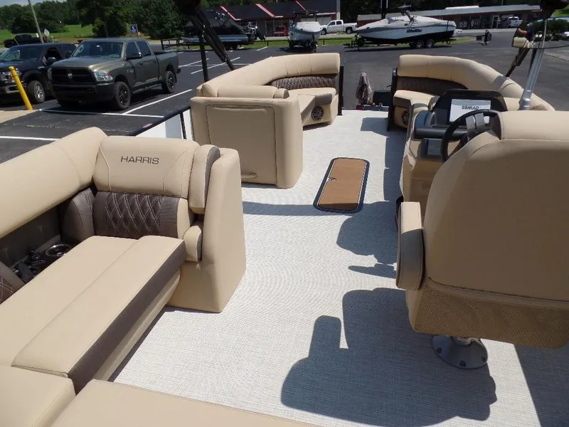 Slide: The Image of 2025 Harris Sunliner 250 pontoon boat with beige seating and modern interior design. - 14