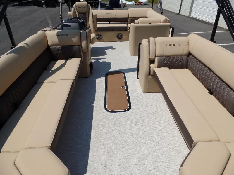 Slide: The Image of 2025 Harris Sunliner 250 pontoon boat interior with beige seating and spacious layout. - 3