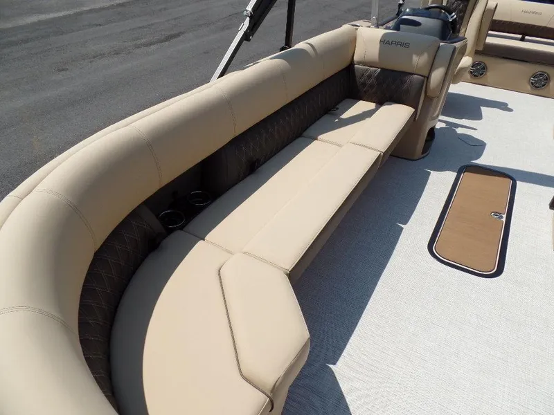 Slide: The Image of 2025 Harris Sunliner 250 boat with beige seating and sleek design. - 5