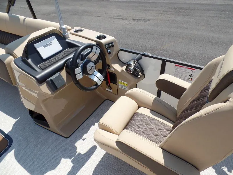 Slide: The Image of 2025 Harris Sunliner 250 boat interior with steering wheel and beige seating. - 6