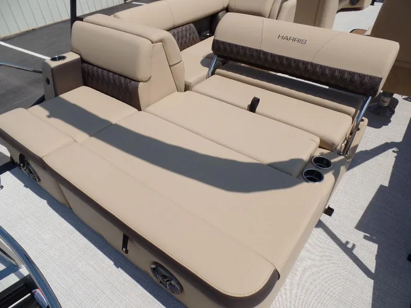 Slide: The Image of 2025 Harris Sunliner 250 boat interior with beige seating and cup holders. - 9