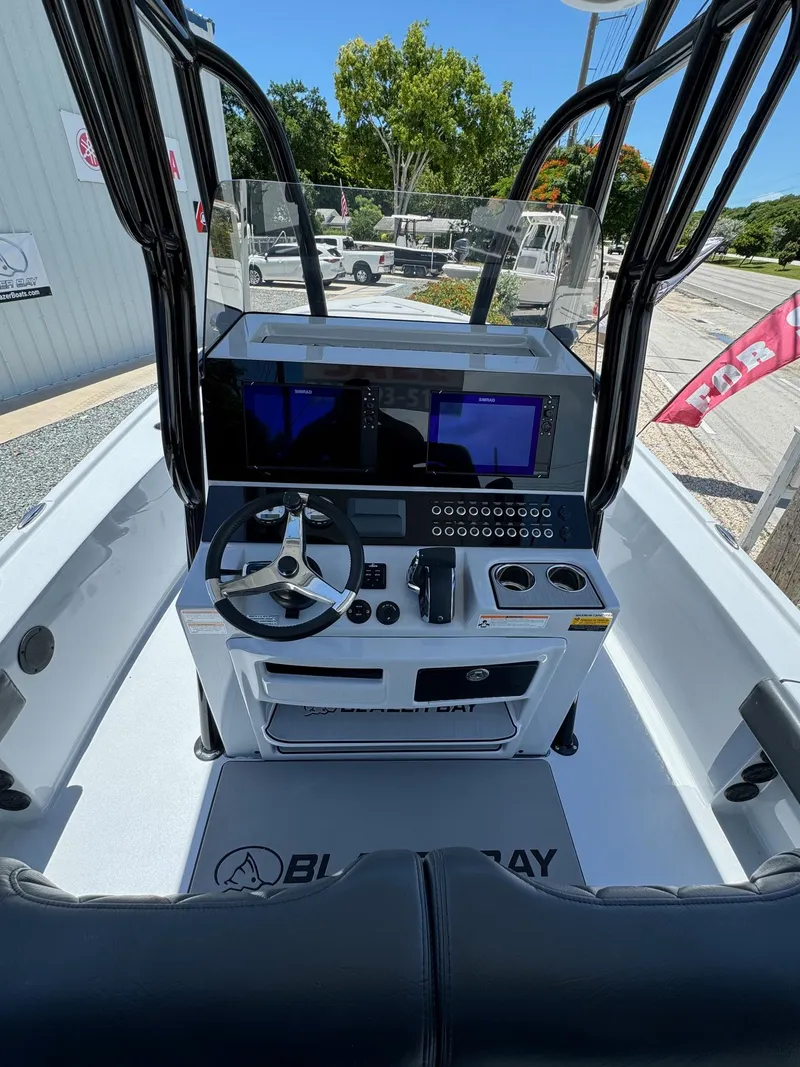 Slide: The Image of 2025 Blazer 2700 HYBRID BAY boat console with advanced navigation system and steering wheel. - 3