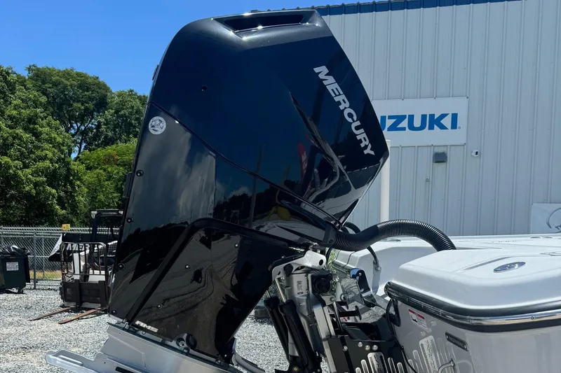 Slide: The Image of Blazer 2700 HYBRID BAY 2025 model with Mercury outboard motor at a Suzuki dealership. - 6