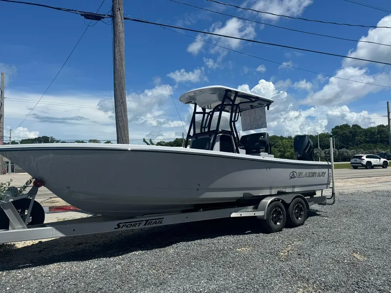 Slide: The Image of 2025 Blazer 2700 HYBRID BAY boat on trailer under blue sky. - 8
