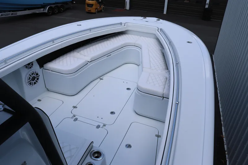 Slide: The Image of 2025 Yellowfin 32 Offshore boat with spacious white seating and storage compartments. - 12