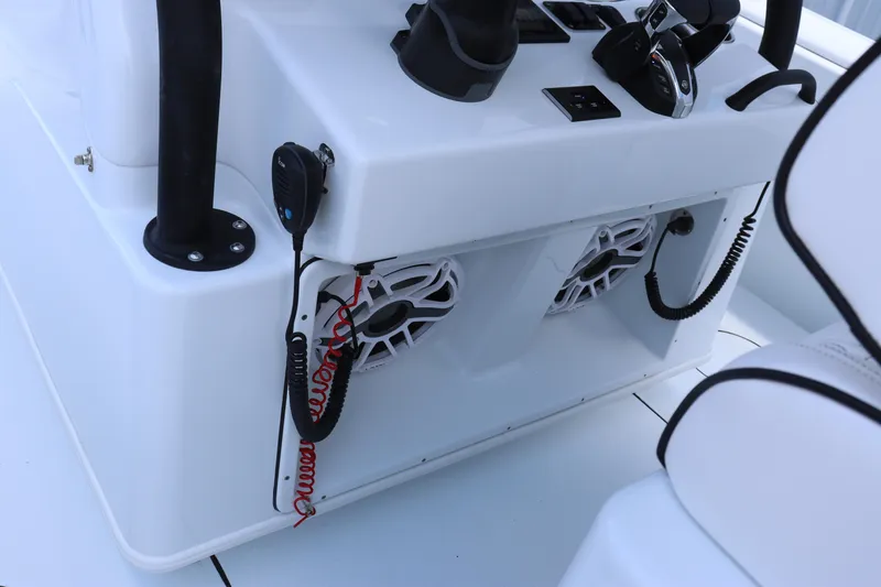 Slide: The Image of 2025 Yellowfin 32 Offshore boat console with speakers and communication equipment. - 16