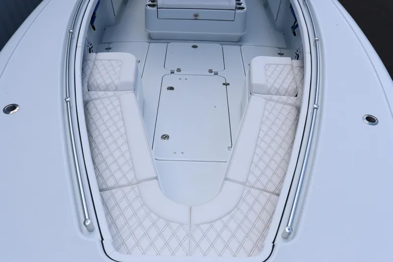 Slide: The Image of 2025 Yellowfin 32 Offshore boat interior with cushioned seating. - 7
