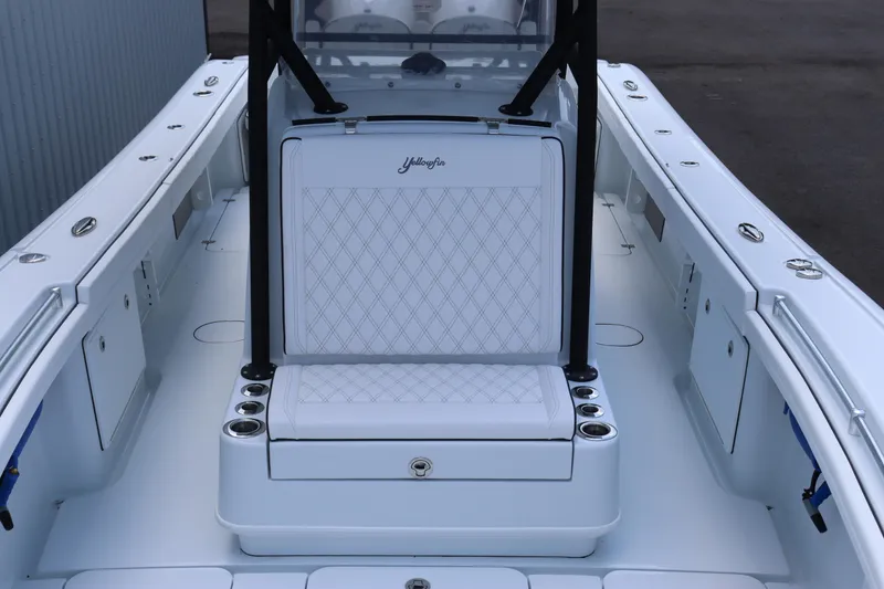 Slide: The Image of 2025 Yellowfin 32 Offshore boat interior with white seating and storage compartments. - 8