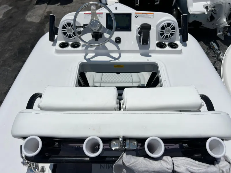 Slide: The Image of 2024 Sportsman Masters 267OE Bay Boat helm with steering wheel and seating. - 13