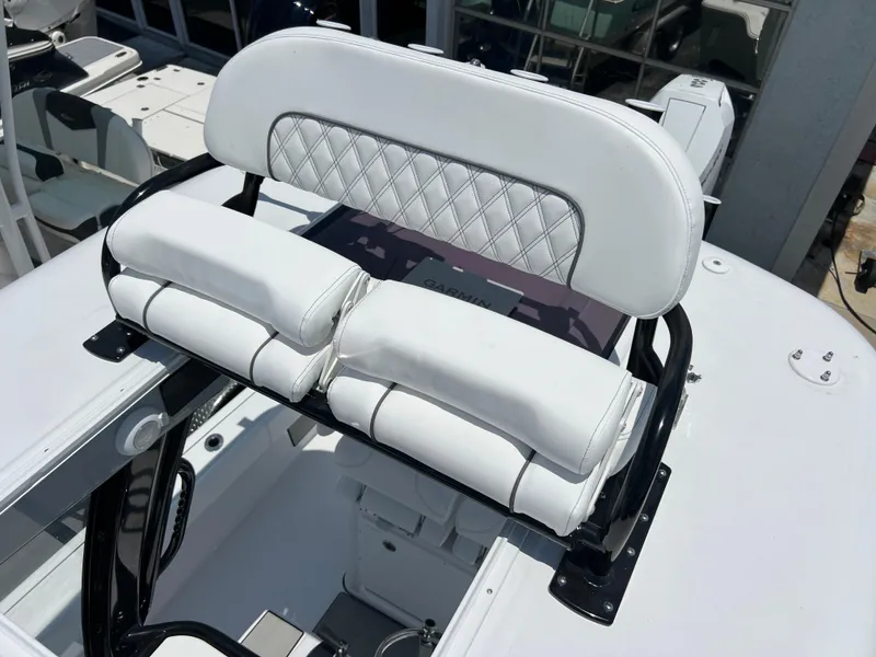 Slide: The Image of 2024 Sportsman Masters 267OE Bay Boat with white cushioned seating. - 15