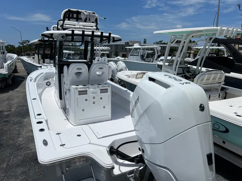 Slide: The Image of 2024 Sportsman Masters 267OE Bay Boat with outboard motor in marina. - 3