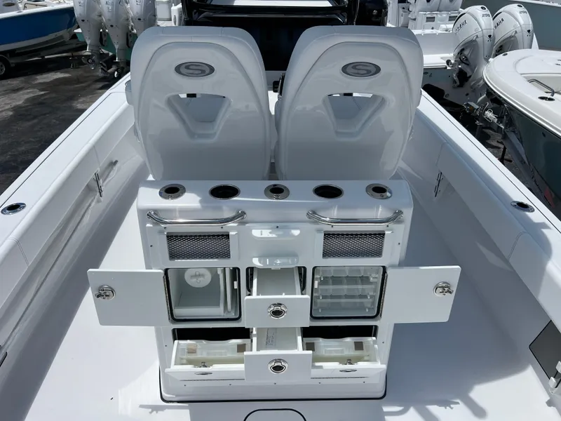 Slide: The Image of 2024 Sportsman Masters 267OE Bay Boat interior with storage compartments and seating. - 5