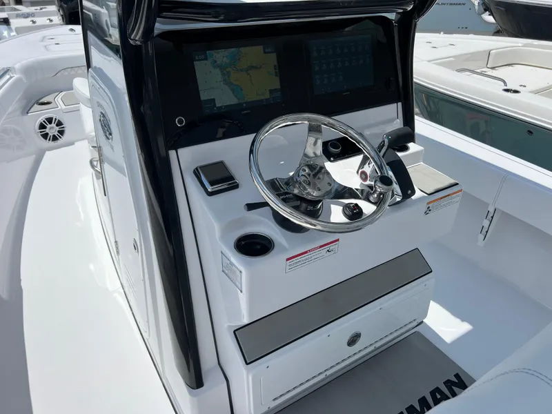 Slide: The Image of 2024 Sportsman Masters 267OE Bay Boat helm with advanced navigation system and sleek steering wheel. - 6
