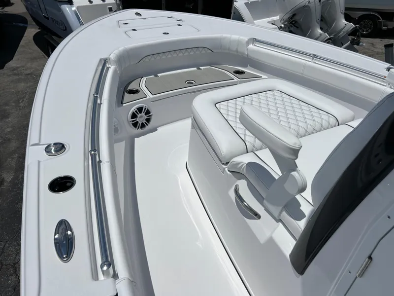 Slide: The Image of 2024 Sportsman Masters 267OE Bay Boat interior with cushioned seating and storage compartments. - 8