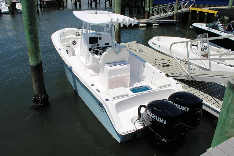 Slide: The Image of 2022 Streamline 26CC boat docked with twin Suzuki outboard motors. - 1
