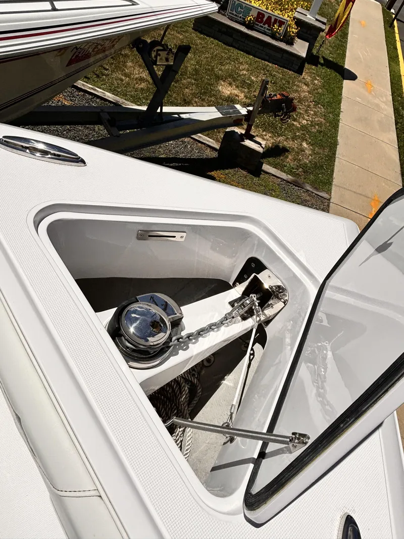 Slide: The Image of 2022 Streamline 26CC boat anchor compartment with open hatch. - 11