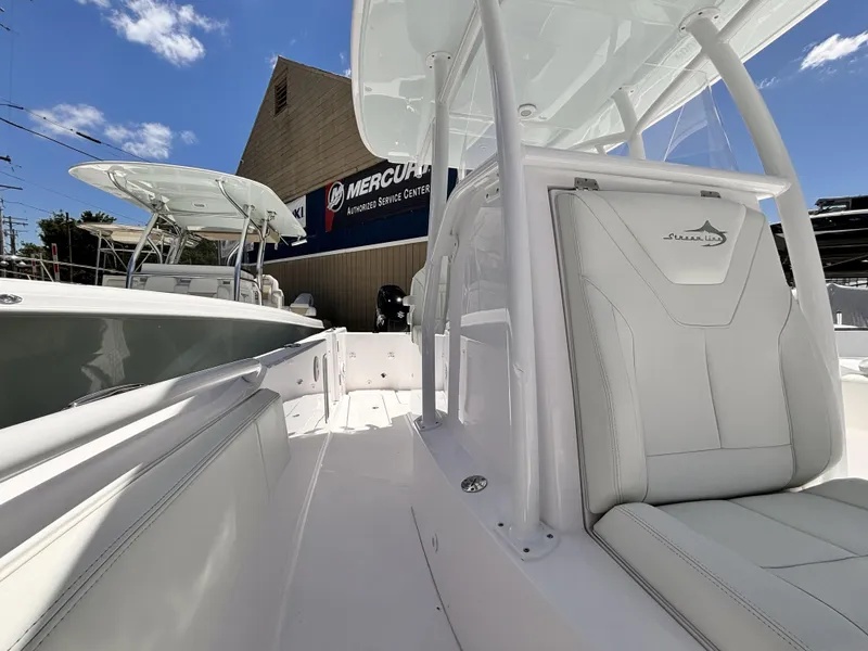 Slide: The Image of 2022 Streamline 26CC boat interior with white seating and console. - 12