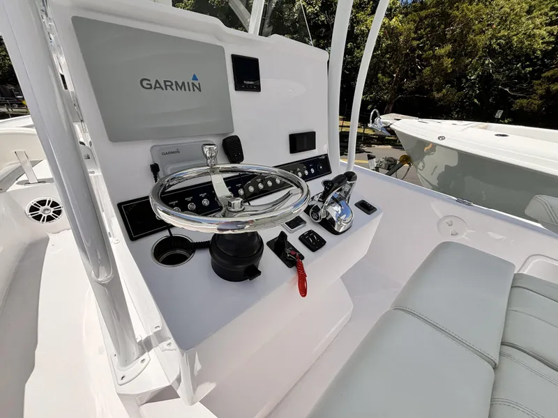 Slide: The Image of 2022 Streamline 26CC boat console with Garmin navigation system and steering wheel. - 6