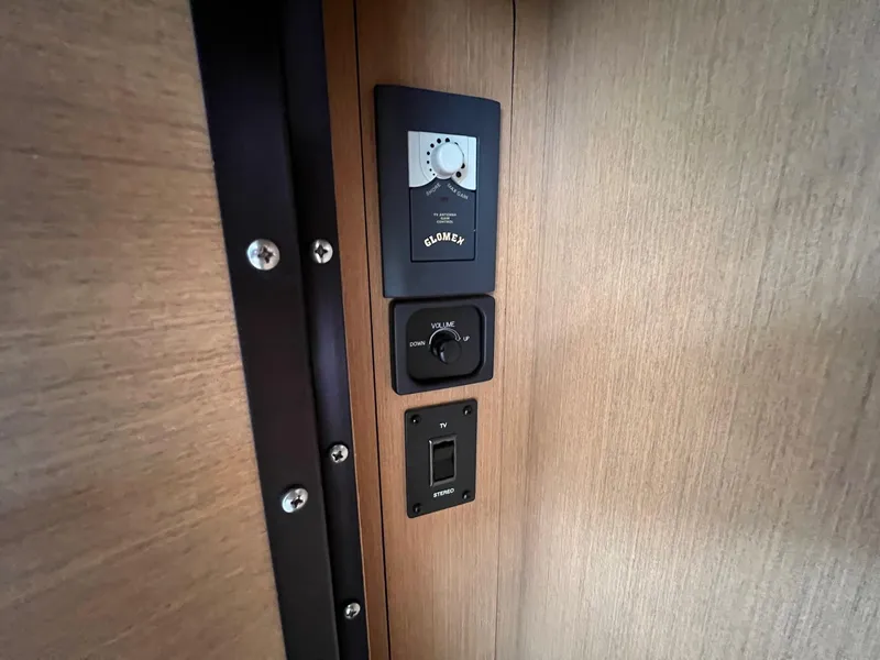 Slide: The Image of Control panel on 2009 Sea Ray 270 Sundancer boat, featuring volume and switch controls. - 14