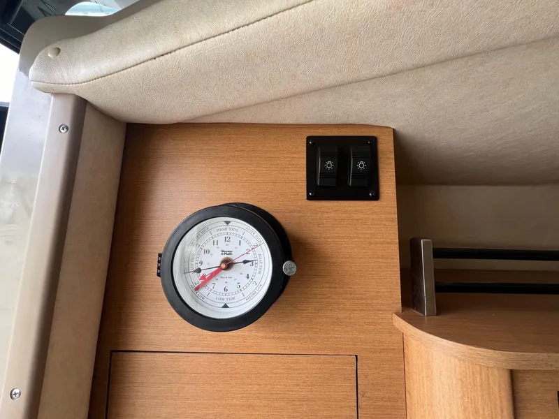 Slide: The Image of Interior of 2009 Sea Ray 270 Sundancer with tide clock and light switches. - 15