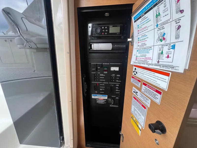 Slide: The Image of Electrical control panel on a 2009 Sea Ray 270 Sundancer boat with safety instructions. - 16