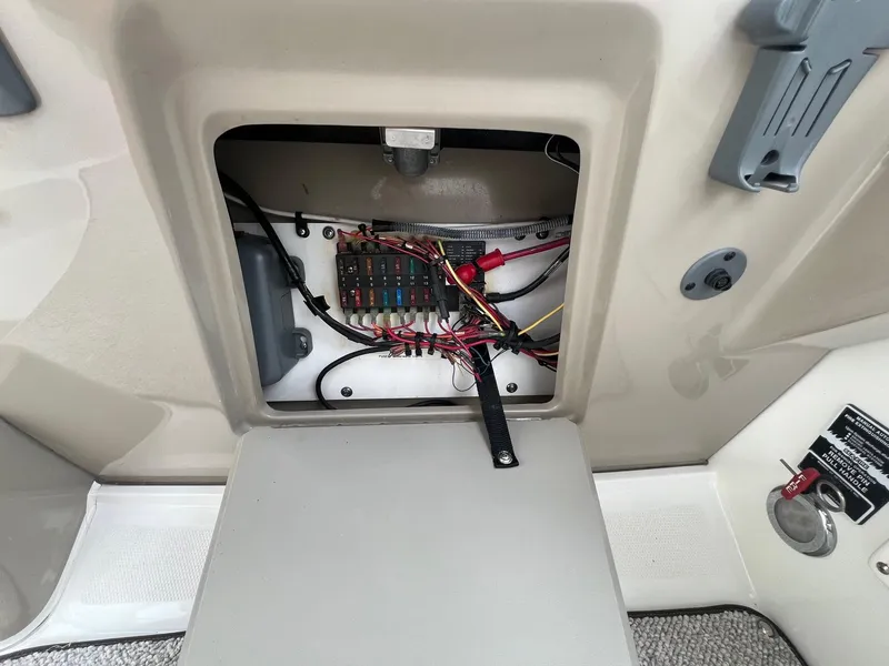 Slide: The Image of Electrical panel inside a 2009 Sea Ray 270 Sundancer boat, showing wiring and fuses. - 20