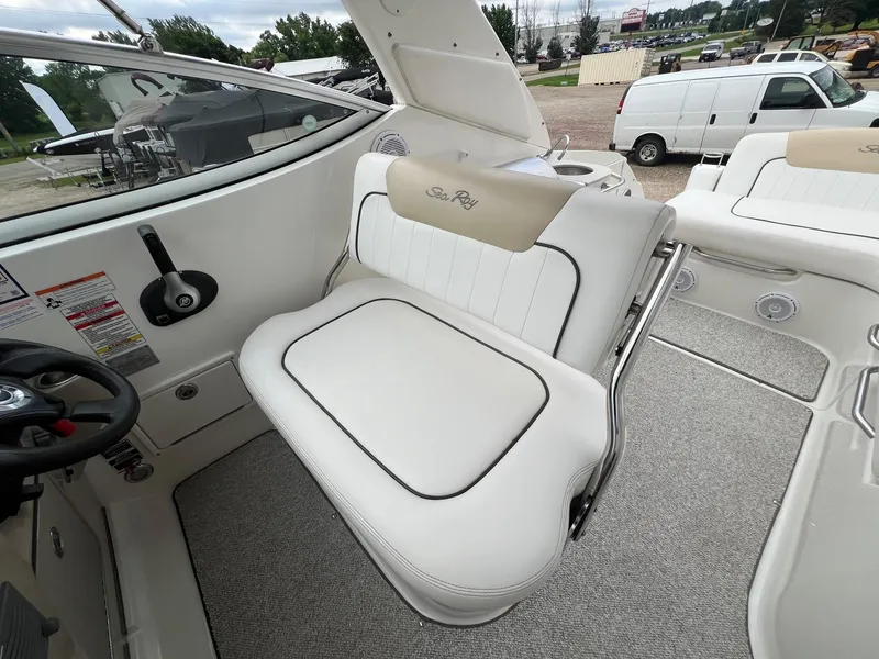 Slide: The Image of 2009 Sea Ray 270 Sundancer interior with white seating and steering wheel. - 22