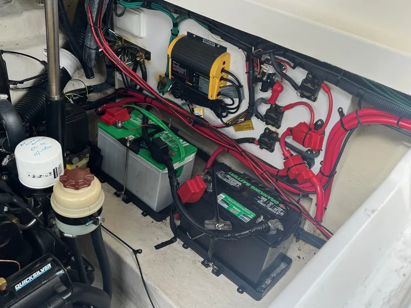 Slide: The Image of Engine compartment of a 2009 Sea Ray 270 Sundancer with batteries and wiring. - 26