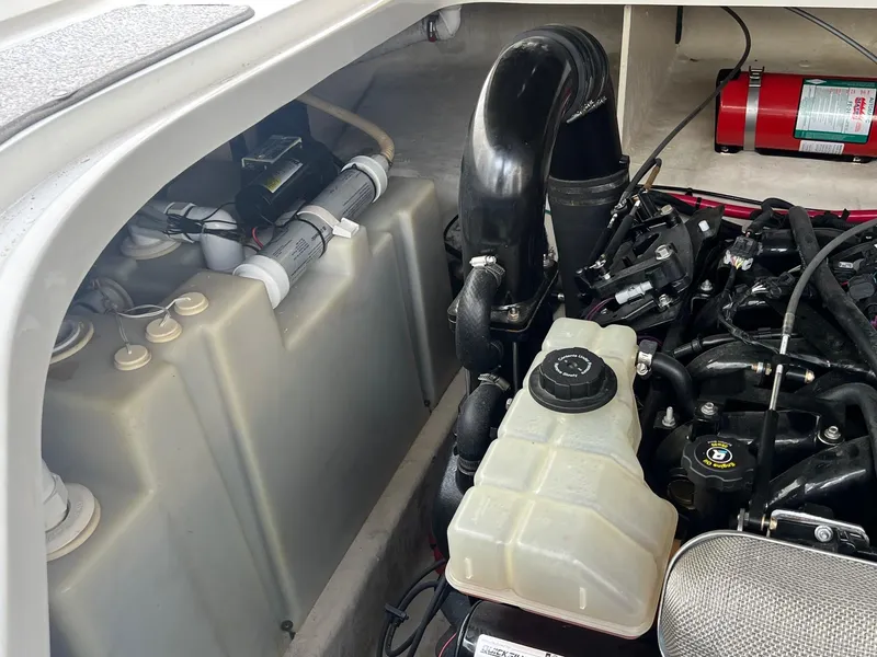 Slide: The Image of Engine compartment of a 2009 Sea Ray 270 Sundancer boat, showing components and fire extinguisher. - 27
