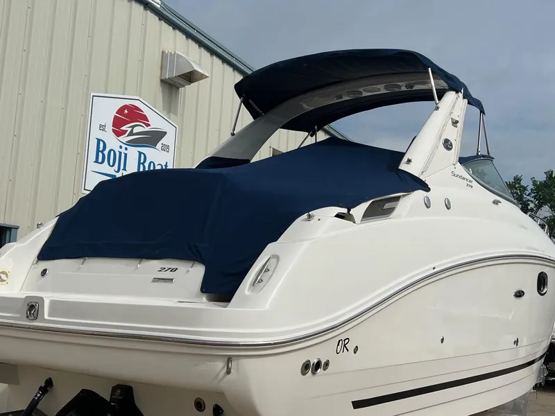 Slide: The Image of 2009 Sea Ray 270 Sundancer boat with blue cover at Boji Boat dealership. - 35