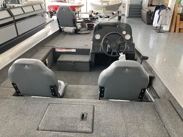 Slide: The Image of 2023 Lowe Skorpion 17 boat interior with steering console and seating. - 3