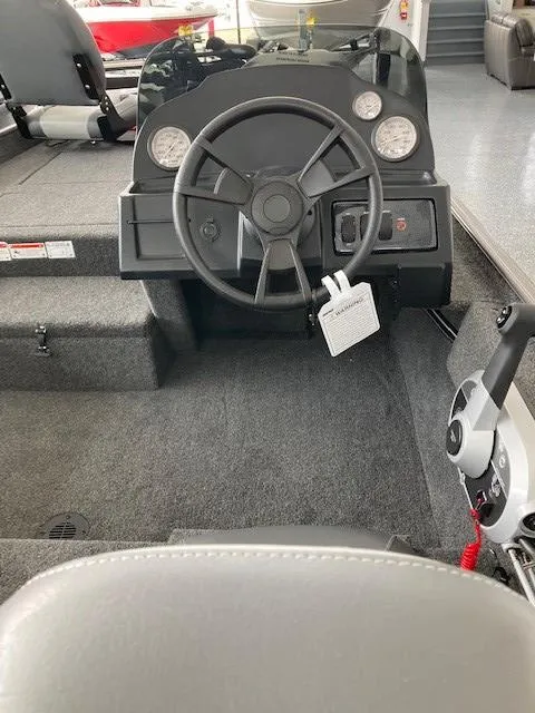Slide: The Image of 2023 Lowe Skorpion 17 boat interior with steering wheel and dashboard. - 4