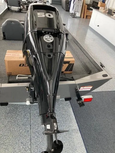 Slide: The Image of 2023 Lowe Skorpion 17 boat with a 50 HP outboard motor in showroom. - 6