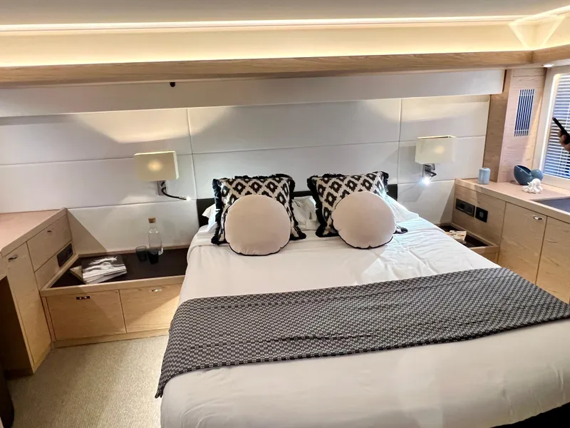 Slide: The Image of Luxurious bedroom in 2025 Beneteau Swift Trawler 54 yacht with modern decor. - 11