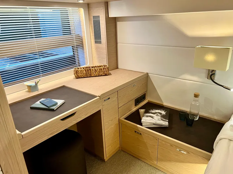 Slide: The Image of Interior cabin of 2025 Beneteau Swift Trawler 54 with desk and storage. - 12